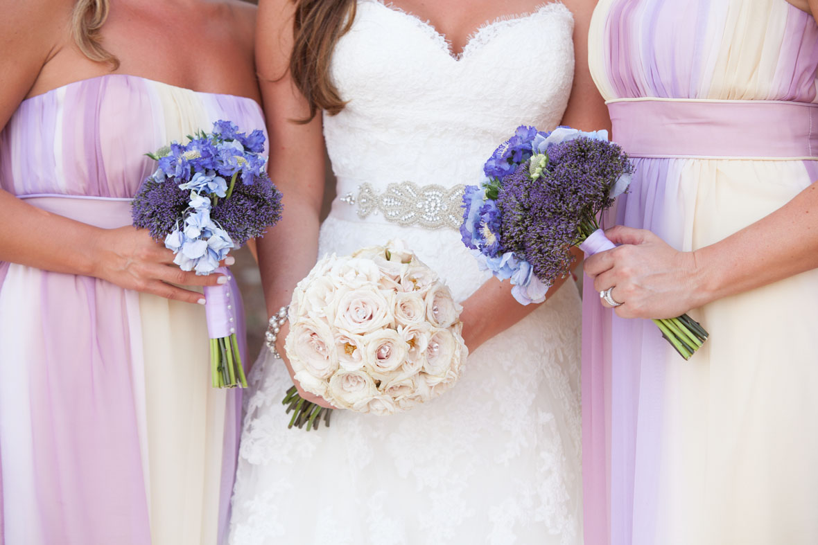 bridesmaids with pastel dresses and purple flowers