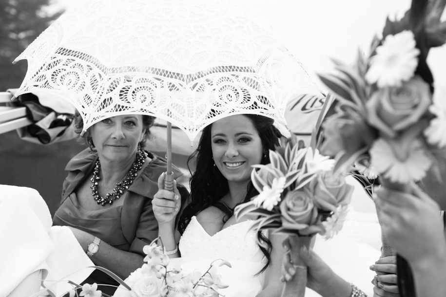 bride and mother of bride riding boat to wedding ceremony on lake in Muskoka, Ontario