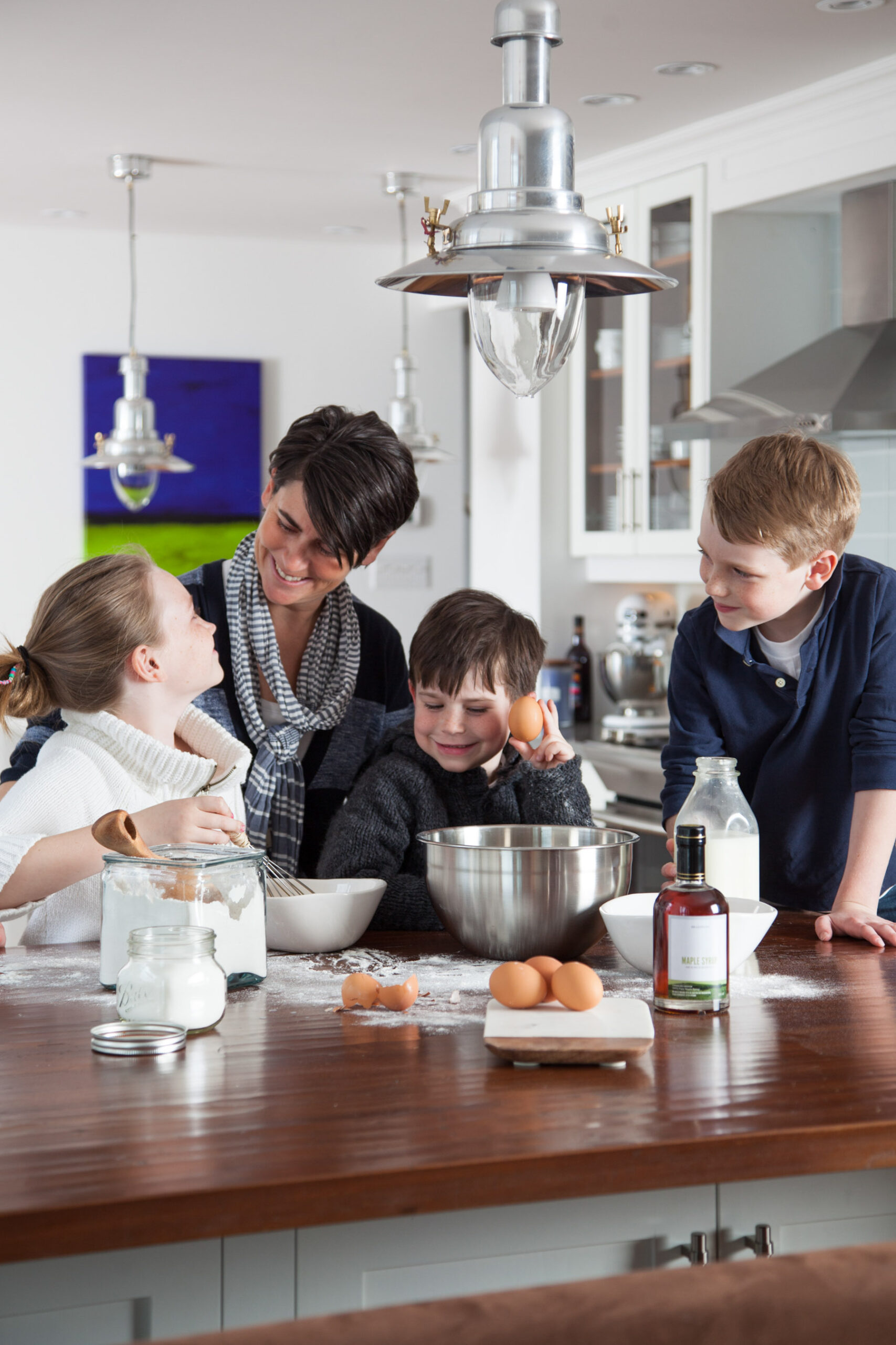 how to use Pancake Tuesday national holiday in your content marketing. Family making pancakes, smiling, and having fun.