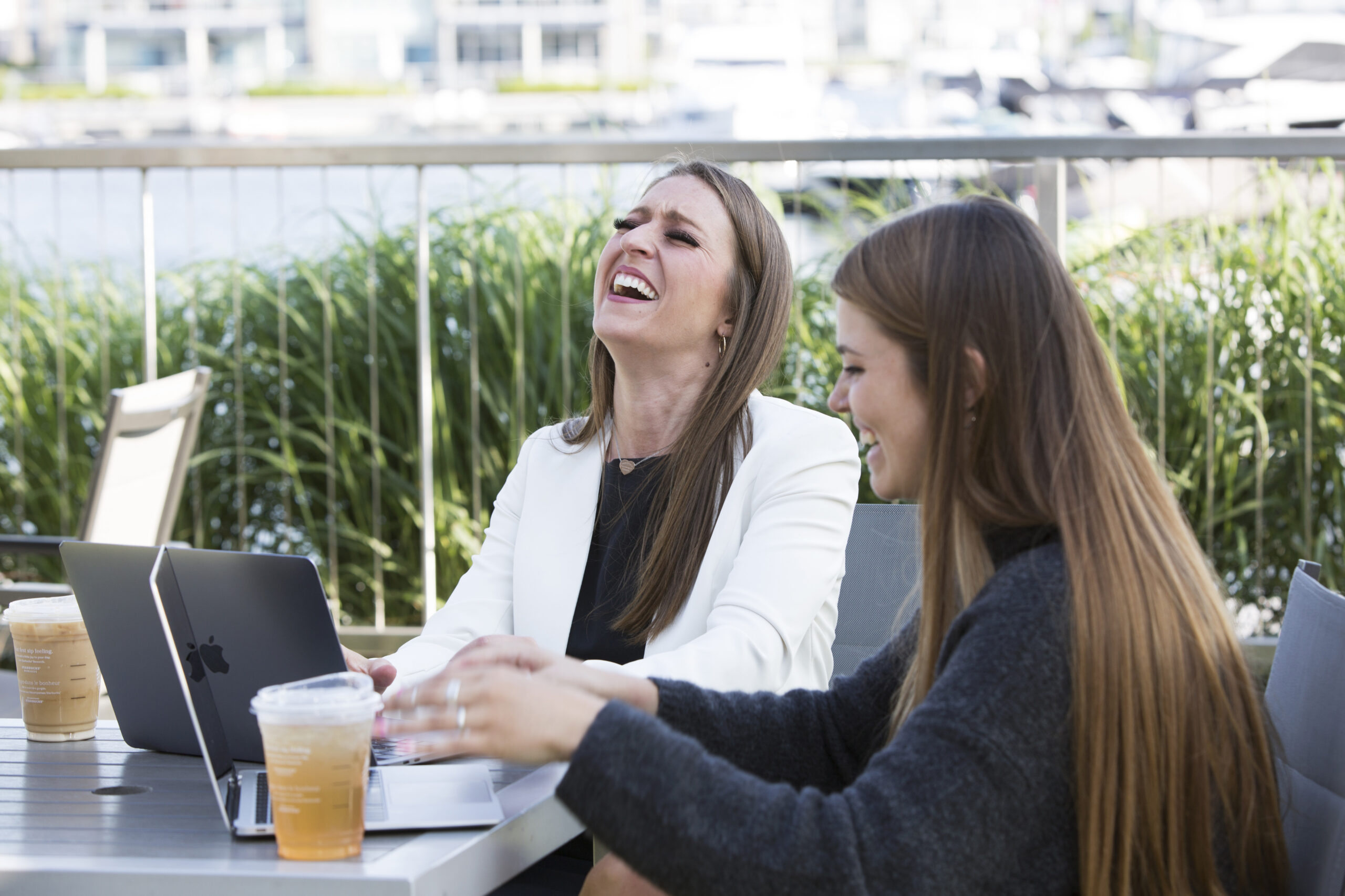 personal branding photo of two women working at table outside