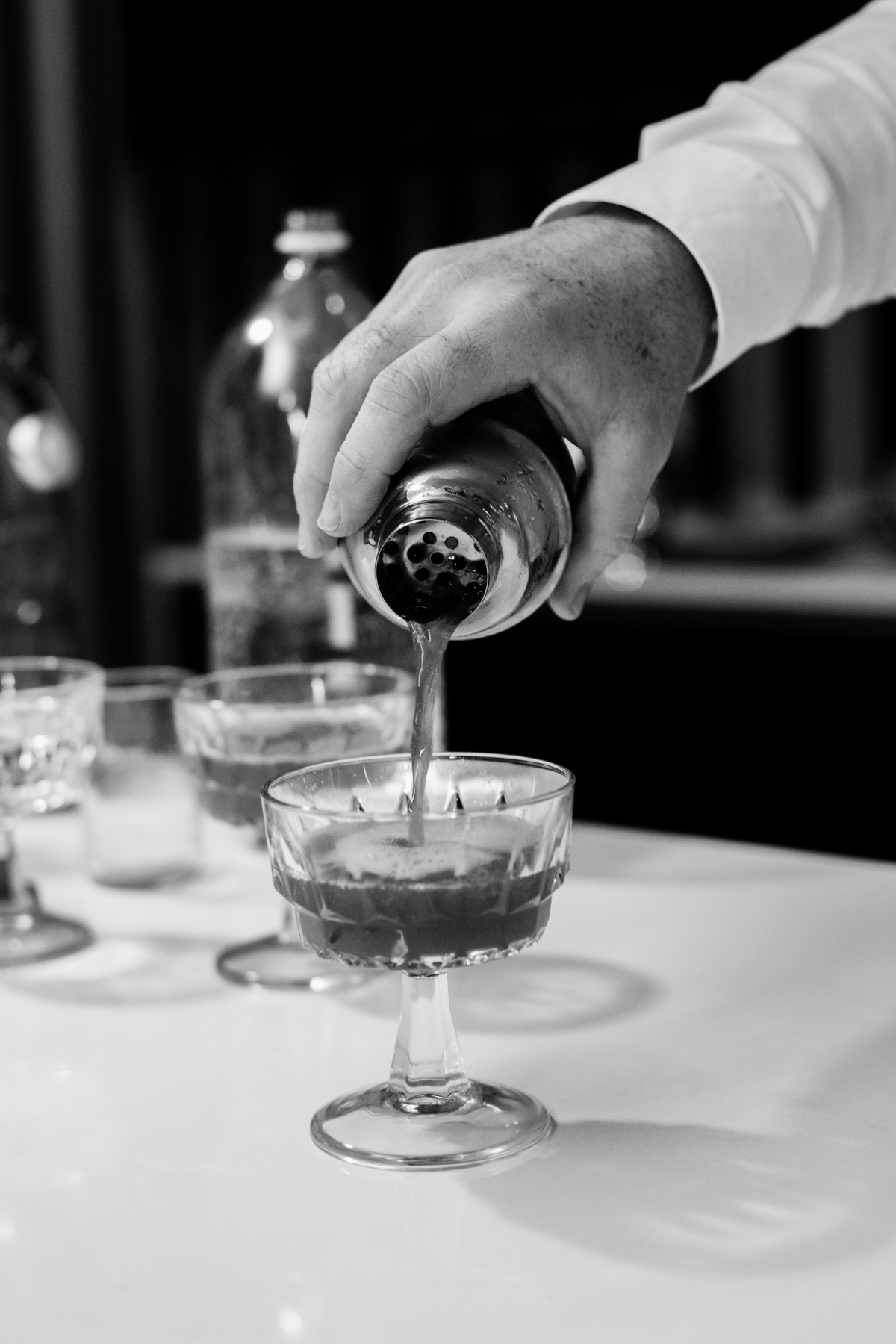 pouring cocktails at Elevate Dinner Party